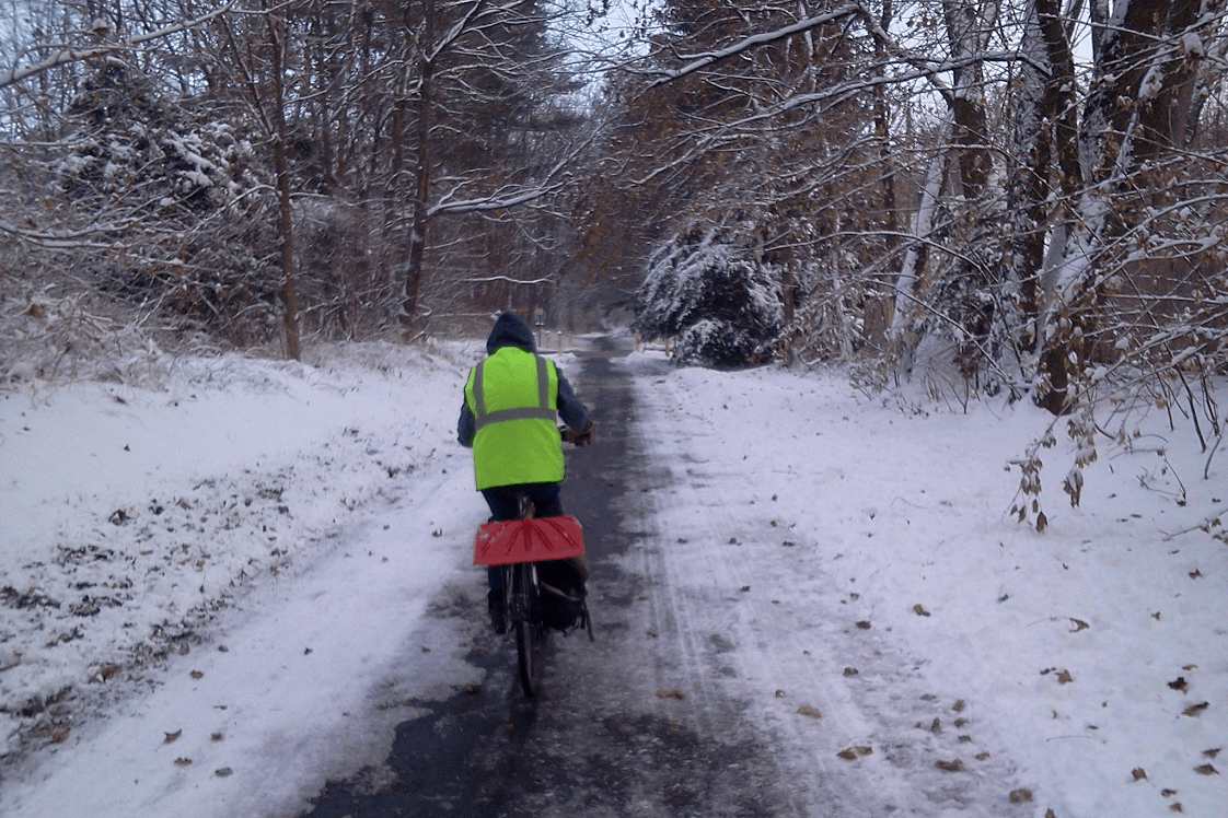 Bicyclist Riding on a Snowy Trail