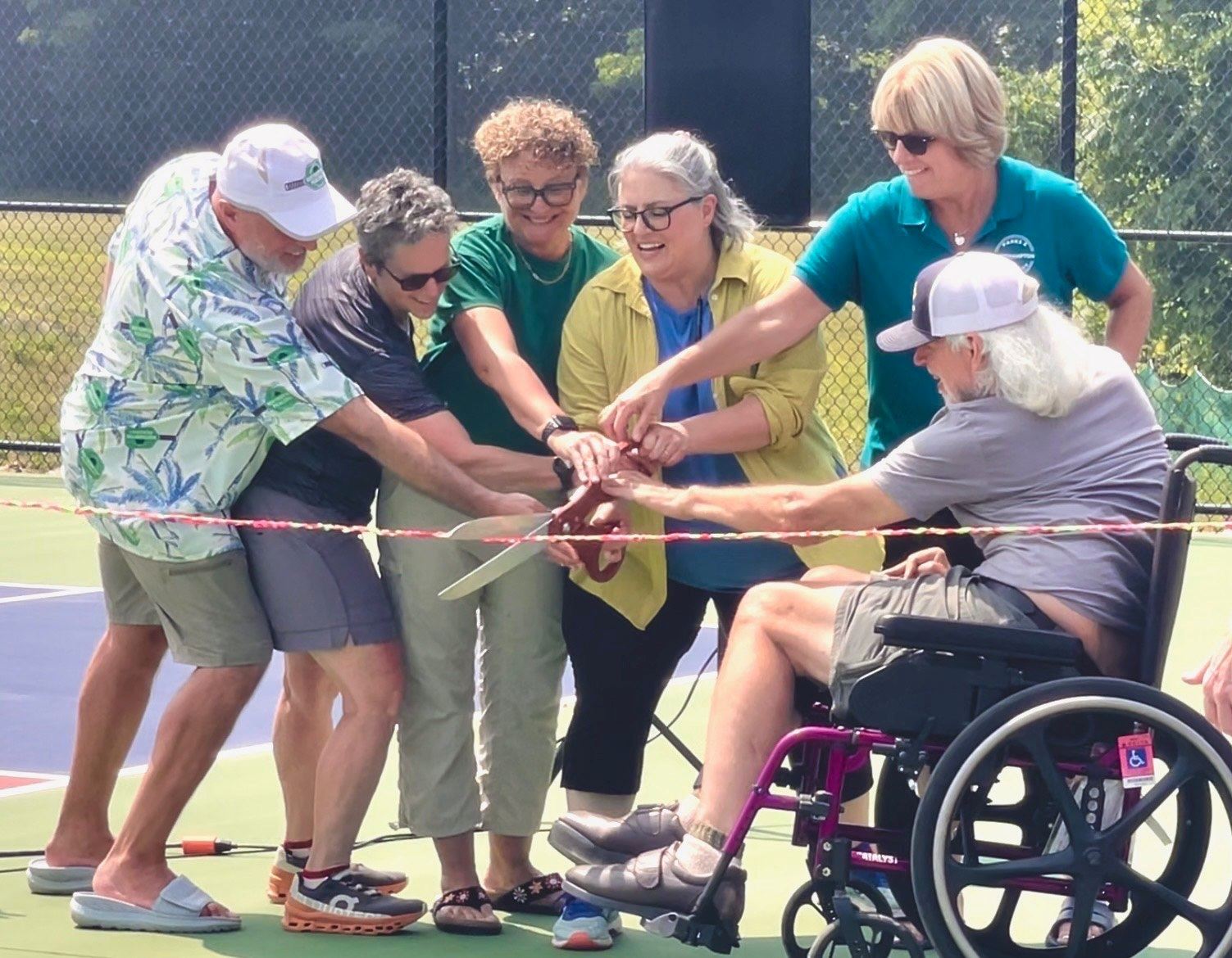 group of 6 including the mayor cutting of ribbon at grand opening