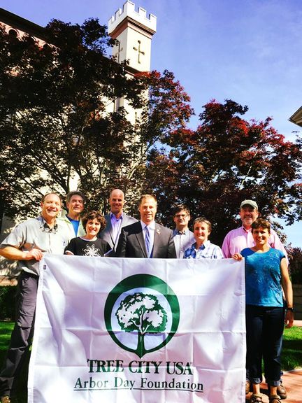 Public Shade Tree Commission Members and Mayor Holding a Tree City USA Banner